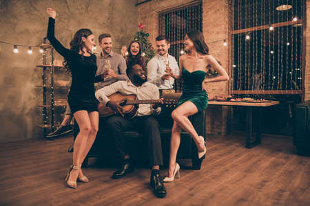 Full body photo of charming fellows enjoy song played by mulatto celebrate christmas night on x-mas...