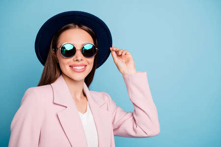 Close up photo of cute enthusiastic hipster girl have fun on stroll enjoy her vacation wear pink autumn coat isolated over blue color backgroundの写真素材