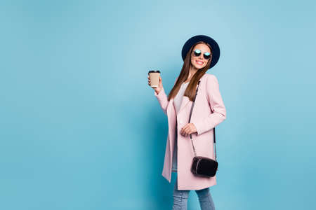 Portrait of lovely sweet girl in eyewear eyeglasses walk have stroll with her friends hold mug wear...