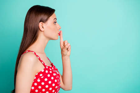 Profile side photo of serious girl placing her index finger face looking wearing polka dot dress...