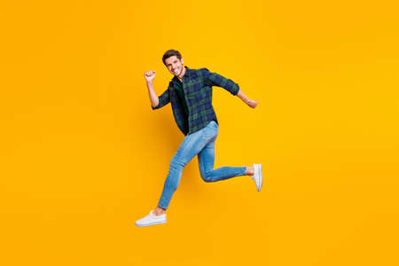 Full length body size photo of cheerful attractive handsome guy going jumping somewhere trendy...