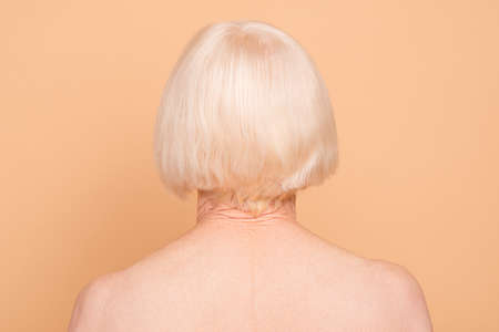 Rear back behind view close-up portrait of her she nice attractive groomed, gray-haired lady after applying mask balm wrap natural oil isolated over beige pastel backgroundの写真素材