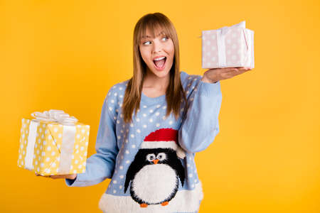 Which box should I put under Chritmas tree on Eve. Photo of thoughtful cheerful optimistic dreamy...