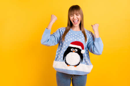 Dreams and wishes come true concept. Photo of excited ecstatic overjoyed rejoicing cheerful cool hipster teenager raising hands fists up having fun isolated vivid color backgroundの写真素材