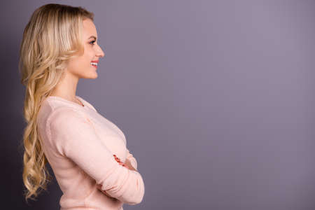 Profile side view portrait of her she nice-looking attractive shine lovely cheerful cheery glad content well-groomed wavy-haired girl folded arms copy space isolated over gray pastel color backgroundの写真素材