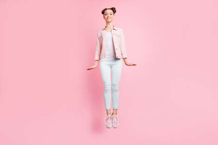 Full length body size view portrait of her she nice-looking attractive, charming lovely lovable winsome cheerful cheery girl having fun time isolated over pink pastel backgroundの写真素材
