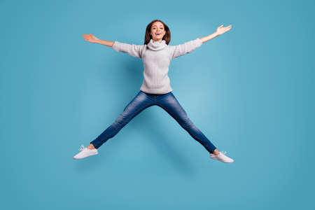 Full size photo of cute candid girl jump like a star feel content wear white, sweater pullover denim...