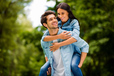 Photo of charming pair walking summer green park enjoy long waited meeting wear denim outfit