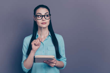 Portrait of her she nice-looking attractive lovely intellectual brainy focused long-haired girl making, notes creating story isolated over gray violet purple pastel color backgroundの写真素材