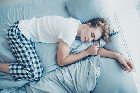 Top above angle photo of calm dreamy man lying on bed sleeping on linen have wonderful dream have...