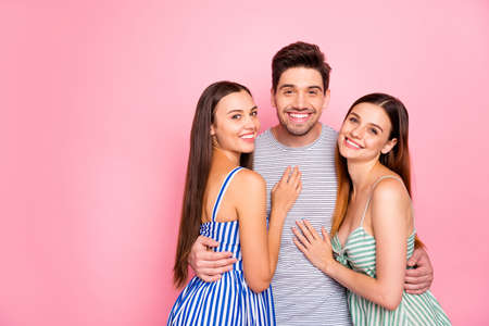 Portrait of cheerful man women with long foxy ginger haircut cuddling smiling wearing striped dress...