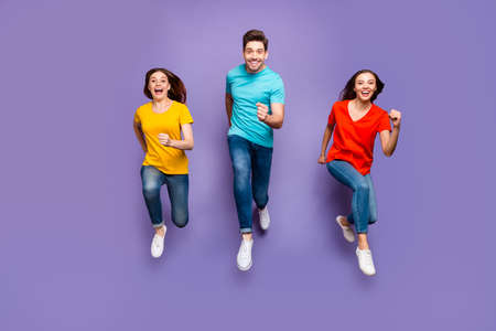 Full length body size front view photo of group of three crazy emotional hipsters models running to...