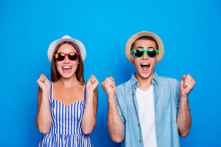 Portrait of his he her she two nice attractive cheerful cheery glad people holding fists anticipating dream holiday tour isolated on bright vivid shine vibrant blue color backgroundの写真素材