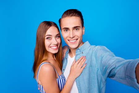 Self-portrait of her she his he two nice attractive lovely sweet tender gentle affectionate cheerful cheery dreamy partners hugging isolated over bright vivid shine vibrant blue color backgroundの写真素材