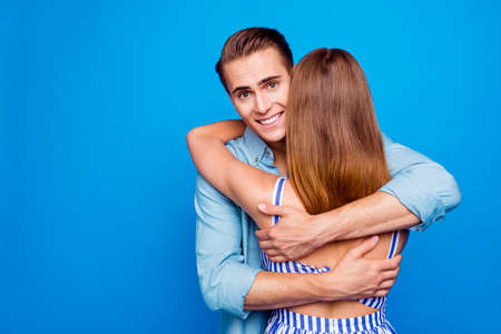 Close-up portrait of her she his he two nice attractive charming gentle cheerful cheery romantic fiance bride hugging isolated over bright vivid shine vibrant blue turquoise color backgroundの写真素材