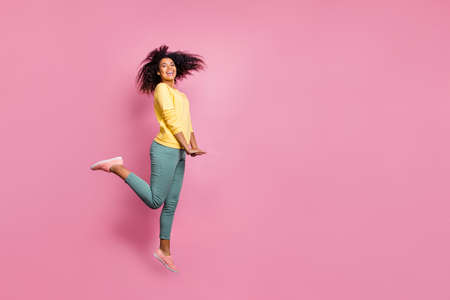 Full length side profile photo of attractive glad nice enjoying life modern hipster jumping up...