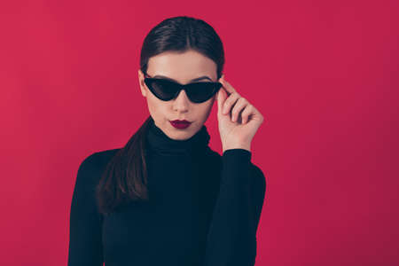 Close up photo of gorgeous magnificent lady entrepreneur look in her eyeglasses, listen real strict boss wear black trend outfit6 isolated over red color backgroundの写真素材
