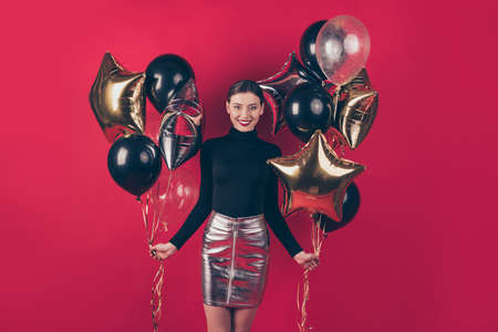 Portrait of her she nice-looking attractive pretty charming cute fascinating, cheerful cheery lady holding in hands air balls festive day isolated on maroon burgundy marsala red pastel color backgroundの写真素材