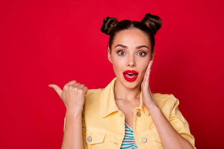 Photo of pretty lady indicating finger empty space enjoy low prices wear casual stylish outfit isolated red backgroundの写真素材