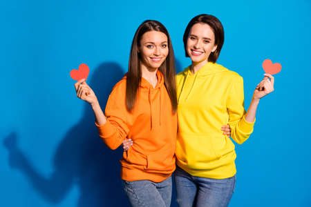 Will you go to prom with me. Photo of two pretty two ladies holding hands little, red paper hearts...