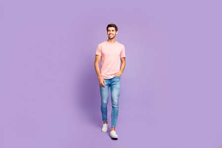Full length body size view of his he nice attractive cheerful cheery content guy wearing pink tshirt...