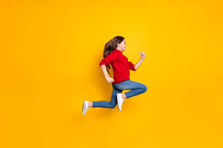 Full length profile side photo of positive cheerful brunette wavy curly hair kid jump run fast...