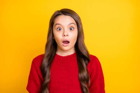 Close up photo of astonished child hear incredible novelty look impressed scream unbelievable wear trend clothes jumper isolated over yellow color backgroundの写真素材