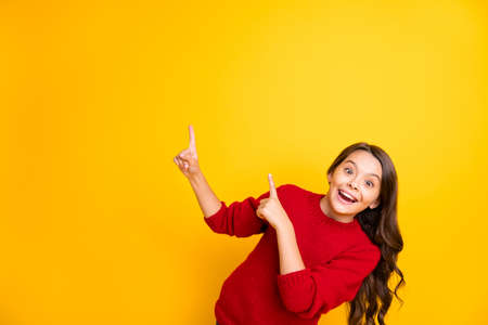 Portrait of funky positive cheerful kid promoter feel crazy point index finger copy space recommend...