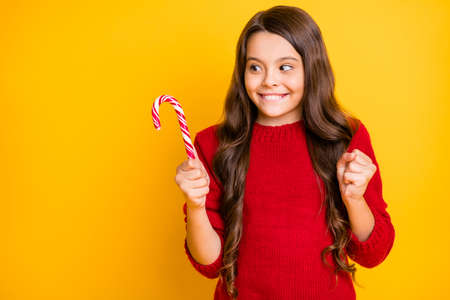 Yummy cant wait. Portrait of funny funky addicted brunette curly hair child hold christmas mint...