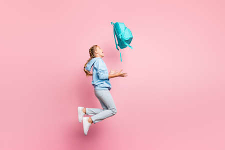 Full body profile photo of pretty little lady jumping high go home after, studying week throwing...