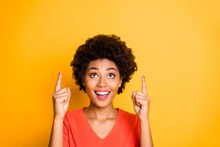 Close up photo of attractive cheerful nice cute pretty sweet black girlfriend pointing up for you to...