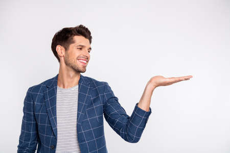 Portrait of his he nice attractive cheerful cheery content businessman agent broker wearing checked blazer holding invisible object on palm isolated over light white pastel backgroundの写真素材