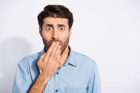 Close up photo of amazing multiethnic guy watching horror movie at cinema holding paln on opem mouth...
