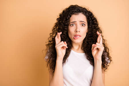 Closeup photo of amazing wavy lady with crossed fingers asking faith lucky victory biting lips...