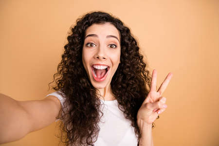 Close up photo of amazing lady making selfies toothy smiling showing v-sign symbol cheerful wear...