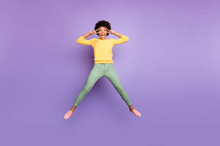 Full body photo of amazed carefree afro american girl jump have fun on autumn spring holidays make...