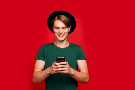 Portrait of positive cheerful guy use his cellphone have communication with friends through social...