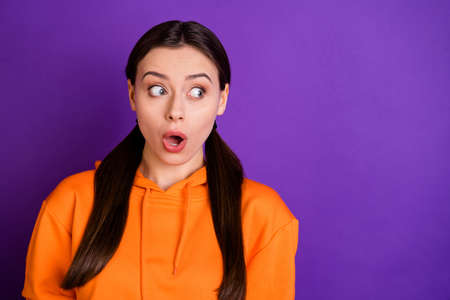Close-up portrait of her she nice attractive lovely cute funny scared girl looking aside feeling fear isolated over bright vivid shine vibrant violet purple lilac color backgroundの写真素材