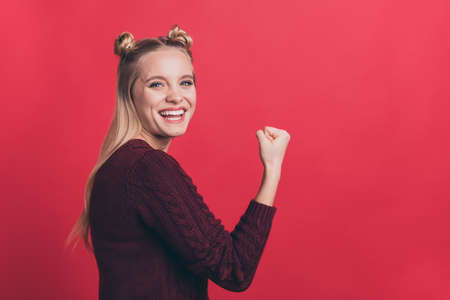 Profile photo of amazing lady overjoyed with great achievement raising fist air rejoicing football fan wear knitted jumper isolated pastel red color backgroundの写真素材