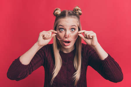 Help me. Photo of amazing lady taking off vision specs dont see at all eyes full fear wear knitted pullover isolated pastel red color backgroundの写真素材