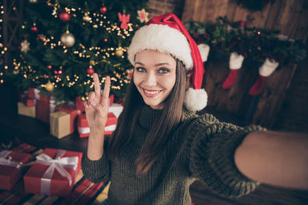 Close up photo of positive newyear blogger brunette hair girl in knitted pullover take selfie make...