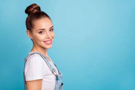 Portrait of lovely cute youth looking smiling wearing white t-shirt denim jeans isolated over blue...
