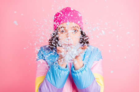 Close-up portrait of her she nice attractive lovely funky girl blowing snow having fun fooling enjoying isolated over pink pastel backgroundの写真素材