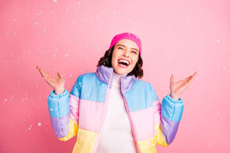 Portrait of her she nice-lookimg attractive lovely cheerful cheery ecstatic girl having fun enjoying snow falling down isolated over pink pastel backgroundの写真素材