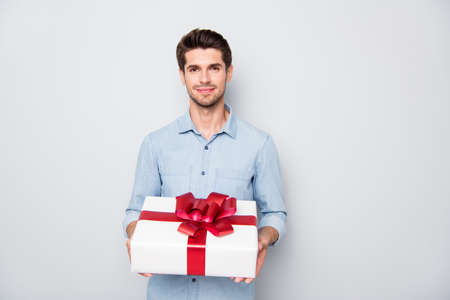 Its for you my love. Portrait of romance romantic lover guy hold gift box present for woman day give to his sweetheart wear stylish clothes isolated over grey color backgroundの写真素材