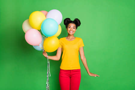 Photo of pretty dark skin lady holding many air balloons came to birthday party wear casual yellow...