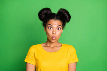 Closeup photo of amazing dark skin lady cant say word make ducky lips facial expression very shy person wear yellow t-shirt isolated green backgroundの写真素材