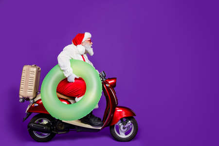 Full body profile photo of santa man going to meet newyear at tropics leaving cold december by bike...