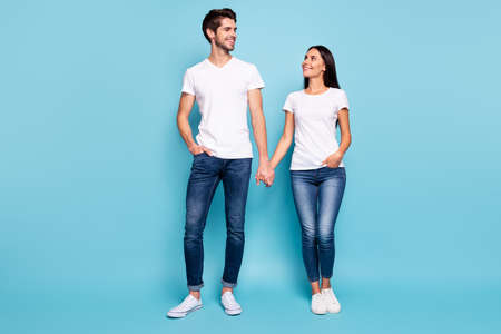 Full length body size view of his he her she nice attractive charming pretty cute sweet cheerful life partners holding hands isolated over bright vivid shine vibrant blue green turquoise backgroundの写真素材