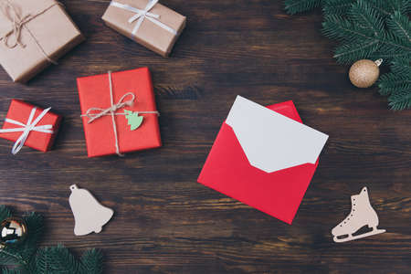 High angle close up above overhead view photo of creative bright envelope with paper card copyspace for text inside many packed giftboxed on rustic backdropの写真素材